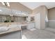 Bright bathroom with dual sinks, shower, soaking tub, and ample counter space at 7460 Grassy Field Ct, Las Vegas, NV 89131