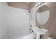 Bathroom with shower-tub combination, pedestal sink, and large vanity mirror at 7460 Grassy Field Ct, Las Vegas, NV 89131