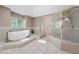 Bathroom featuring a modern standalone tub and separate glass enclosed shower at 7460 Grassy Field Ct, Las Vegas, NV 89131