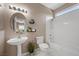 Bathroom featuring a bathtub, shower, vanity, toilet and plant accents at 7460 Grassy Field Ct, Las Vegas, NV 89131