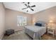 Bedroom with neutral walls, ceiling fan, carpet and large window providing natural light at 7460 Grassy Field Ct, Las Vegas, NV 89131