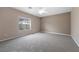 A serene bedroom with a ceiling fan and plush gray carpeting at 7460 Grassy Field Ct, Las Vegas, NV 89131