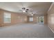 Expansive bedroom with wall to wall carpeting, ceiling fans and access to the backyard through french doors at 7460 Grassy Field Ct, Las Vegas, NV 89131