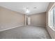 A well lit carpeted bedroom with neutral walls and a ceiling fan at 7460 Grassy Field Ct, Las Vegas, NV 89131