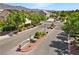 Gated community entrance with beautiful landscaping and mountain views, enhancing security and appeal at 7460 Grassy Field Ct, Las Vegas, NV 89131