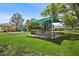 Community park with a playground, picnic tables under a shaded canopy, and lush green grass at 7460 Grassy Field Ct, Las Vegas, NV 89131