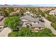 Two-story home with manicured landscaping, solar panels, and a charming front porch and circular drive at 7460 Grassy Field Ct, Las Vegas, NV 89131