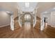 Elegant foyer with a grand staircase, hardwood floors, and stylish chandelier at 7460 Grassy Field Ct, Las Vegas, NV 89131