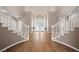 Grand foyer featuring a dual staircase, hardwood floors, and elegant double doors at 7460 Grassy Field Ct, Las Vegas, NV 89131