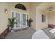 Inviting front porch with double doors, potted plants, and decorative light fixtures at 7460 Grassy Field Ct, Las Vegas, NV 89131