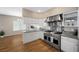 Modern kitchen featuring stainless steel appliances and white cabinetry at 7460 Grassy Field Ct, Las Vegas, NV 89131