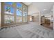 Open-concept living area featuring large windows, high ceilings, and neutral decor at 7460 Grassy Field Ct, Las Vegas, NV 89131