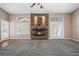 Cozy living room features a stone fireplace, ceiling fan, and access to the exterior at 7460 Grassy Field Ct, Las Vegas, NV 89131