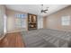 Spacious living room featuring a stone fireplace, ceiling fan, and access to the exterior at 7460 Grassy Field Ct, Las Vegas, NV 89131