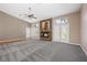 Open living room featuring a stone fireplace, ceiling fan, and french doors at 7460 Grassy Field Ct, Las Vegas, NV 89131
