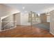 Bright living room with hardwood floors and large windows offering natural light at 7460 Grassy Field Ct, Las Vegas, NV 89131