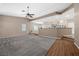 Bright, open living room with stone fireplace open to the kitchen and featuring hardwood floors at 7460 Grassy Field Ct, Las Vegas, NV 89131