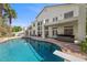 Gorgeous backyard pool with diving board, spa, covered patio, and lush landscaping create a private oasis at 7460 Grassy Field Ct, Las Vegas, NV 89131