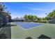Outdoor tennis court featuring a blue court surface and well-maintained green surroundings at 7460 Grassy Field Ct, Las Vegas, NV 89131