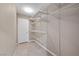 A bright walk-in closet with built-in shelving and tile flooring at 7460 Grassy Field Ct, Las Vegas, NV 89131