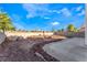 Backyard features a desert landscaped yard with a brick lined concrete patio and fire pit at 7912 Painted Rock Ln, Las Vegas, NV 89149