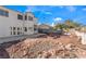 Backyard features a desert landscaped yard, brick lined patio, and exterior home view at 7912 Painted Rock Ln, Las Vegas, NV 89149