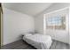 A bright bedroom has gray flooring and a comfortable bed with great natural light at 7912 Painted Rock Ln, Las Vegas, NV 89149
