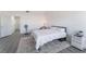 A well-lit bedroom features a plush bed, sleek flooring, and a contemporary aesthetic at 7912 Painted Rock Ln, Las Vegas, NV 89149