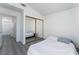 Bright bedroom features hardwood floors, mirrored closet doors, and a vaulted ceiling at 7912 Painted Rock Ln, Las Vegas, NV 89149