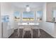 Cozy dining area featuring bright natural light, modern light fixture and outdoor views at 7912 Painted Rock Ln, Las Vegas, NV 89149