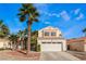 Home featuring desert landscaping, a two-car garage, and well manicured trees at 7912 Painted Rock Ln, Las Vegas, NV 89149