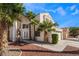 Elegant home showcasing lush landscaping, a driveway, and architectural design at 7912 Painted Rock Ln, Las Vegas, NV 89149
