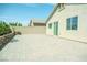 Paver patio and backyard of home with brick wall and well-maintained landscaping at 8223 Buffalo Ranch Ave, Las Vegas, NV 89147