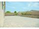 Spacious paved backyard featuring mature landscaping and a sturdy brick perimeter wall at 8223 Buffalo Ranch Ave, Las Vegas, NV 89147