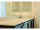 Bathroom vanity featuring a light countertop, dark cabinets, and modern fixtures at 8223 Buffalo Ranch Ave, Las Vegas, NV 89147