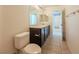 Bathroom with dark brown cabinets, tile floors, and standard toilet at 8223 Buffalo Ranch Ave, Las Vegas, NV 89147