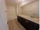 Bathroom featuring dark brown cabinets, standard toilet, and neutral colors at 8223 Buffalo Ranch Ave, Las Vegas, NV 89147