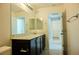 Bathroom with a dark vanity cabinet, granite countertop, and decorative mirror at 8223 Buffalo Ranch Ave, Las Vegas, NV 89147