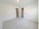 Bright bedroom with light gray wood-look flooring, fresh white paint, and walk in closet at 8223 Buffalo Ranch Ave, Las Vegas, NV 89147