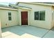 Covered front entrance with neutral stucco and modern window accents at 8223 Buffalo Ranch Ave, Las Vegas, NV 89147