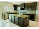 Modern kitchen with an island, stainless steel appliances, and sleek cabinetry at 8223 Buffalo Ranch Ave, Las Vegas, NV 89147