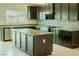 Spacious kitchen island, stainless appliances, granite countertops, and stylish backsplash in this inviting cooking space at 8223 Buffalo Ranch Ave, Las Vegas, NV 89147