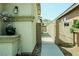 Gated side yard entrance with desert landscaping and security sign at 8223 Buffalo Ranch Ave, Las Vegas, NV 89147