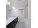 Clean bathroom showcasing dual sinks with a marble countertop, dark wood cabinets, and a shower-tub combination at 8276 Sorrel St, Las Vegas, NV 89139