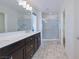 Bright bathroom with a double sink vanity and a glass-enclosed shower at 8276 Sorrel St, Las Vegas, NV 89139