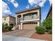 Charming two-story home featuring a front-facing balcony and a well-maintained, stylish brick driveway at 8276 Sorrel St, Las Vegas, NV 89139
