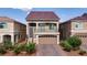 Lovely two-story home with a front-facing balcony and well-manicured landscaping, featuring a stylish brick driveway at 8276 Sorrel St, Las Vegas, NV 89139