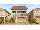 Charming two-story home features a red-tile roof, balcony, and a two-car garage with paver driveway at 8276 Sorrel St, Las Vegas, NV 89139