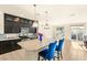 Bright kitchen with a granite island, dark cabinets, stainless appliances, and tiled flooring at 8276 Sorrel St, Las Vegas, NV 89139
