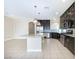 Spacious kitchen featuring a center island, stainless steel appliances, and dark cabinets in an open layout at 8276 Sorrel St, Las Vegas, NV 89139